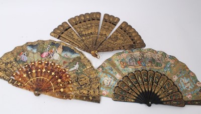 Lot 884 - Ornate 19th century Chinese lacquered fan, with continuous finely decorated figural frieze, 29cm high, together with two Continental fans