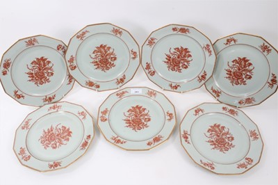 Lot 263 - Seventeen modern Limoges dinner plates, hand painted in red enamel and gilt with a floral pattern, 25cm diameter