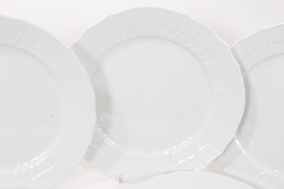 Lot 267 - Twenty-eight Royal Copenhagen blanc de chine dinner plates, with spiral fluting and moulded basket weave borders, 25cm diameter