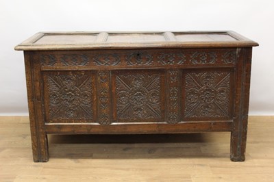 Lot 1430 - 17th century carved oak coffer, with triple panel hinged top and scroll carved frieze over triple carved panel front on high stiles, 132cm wide x 56cm deep x 75cm high