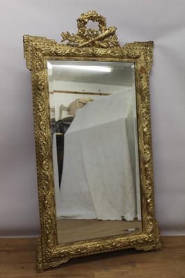 Lot 1447 - Neoclassical style gilt wall mirror, rectangular bevelled plate with trophy cresting and scrolled kit-kat style cushion frame , 145 x 79cm