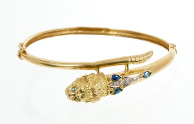 Lot 609 - 18ct gold bangle with lion's head terminal set with sapphires and diamonds