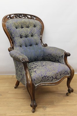 Lot 1459 - Victorian carved walnut open armchair, with button upholstered spoon back and seat within pierced carved showwood frame with cabriole legs and castors