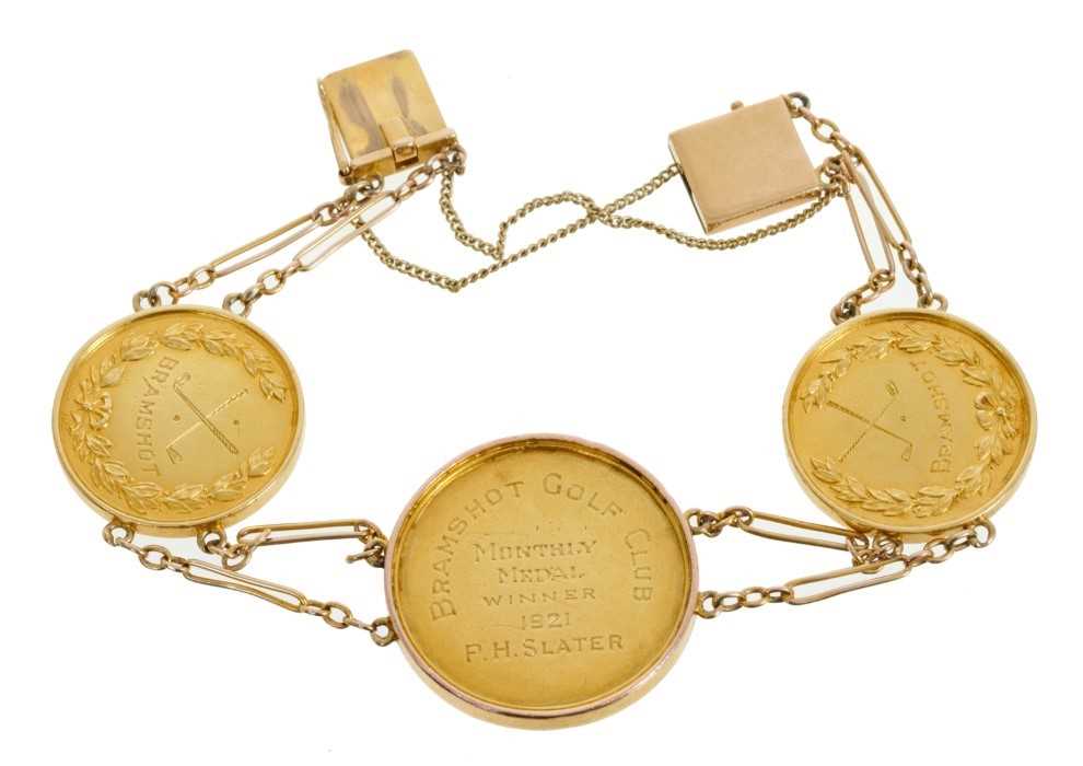 Lot 606 - Early 20th century gold bracelet composed of three gold Golfing medals from Bramshot golf club