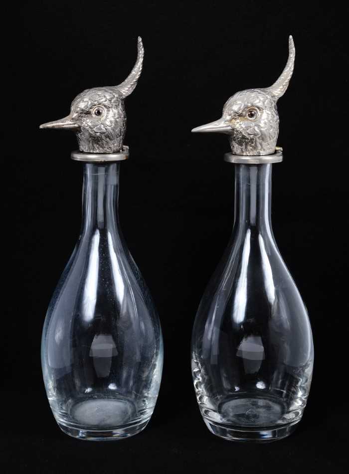 Lot 401 - A pair of modern mallet-shaped glass decanters, the hinged tops formed as silver plated lapwing's heads, realistically chased with plumage, 35.5cm high