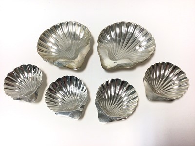 Lot 315 - Pair Edwardian silver butter shells of conventional form, on three ball feet (Birmingham 1906) Williams (Birmingham) Ltd, together with a set of four smaller pairs of butter shells (Sheffield 1920/...