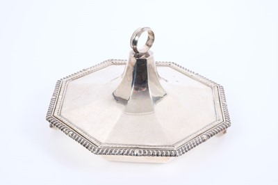 Lot 404 - Edwardian sterling silver entree dish, by William Comyns, London 1911, of octagonal form, twin-handled with gadrooned edge, 22cm wide and weighing 27.3 troy oz.