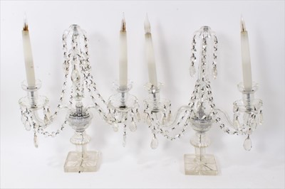 Lot 276 - A pair of Edwardian cut glass candelabra, each with twin arms, converted to electric and measuring 46cm high