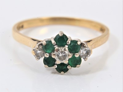 Lot 618 - Emerald and diamond cluster ring with three brilliant cut diamonds and six emeralds in claw setting on 18ct yellow gold shank. Ring size S½.