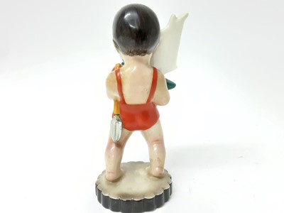 Lot 1194 - Lenci figure of a young boy in a swimming costume, holding a toy boat, spade and ball, marked 'Lenci Made in Italy' to base
