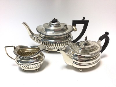 Lot 385 - 1920s silver teapot of half fluted form, with  matching cream jug ( London 1920) Maker's mark rubbed