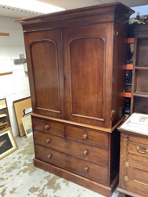 Lot 1460 - Victorian mahogany linen press, with concave cornice and interior of slides enclosed by pair of arched panel doors, with two short over two long drawers on plinth base, 127cm wide x 57cm deep x 206...