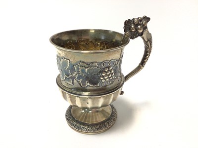 Lot 413 - Good quality late Victorian silver christening mug with fluted decoration below a band of chased fruiting vine decoration, raised on pedestal foot, (London 1899), maker Carrington & Co, 11.3cm in o...