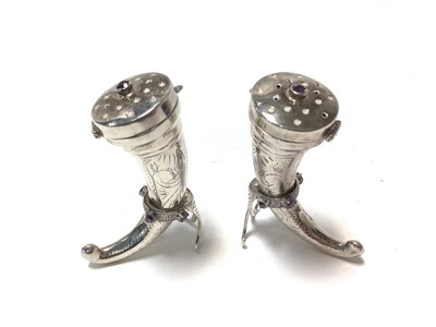 Lot 428 - Pair of silver pepperettes in the form of Norwegian drinking horns with engraved decoration and pierced hinged covers, stamped 925, each 6.5cm in height