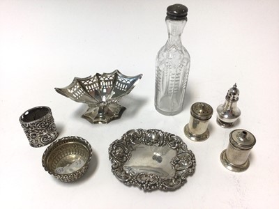 Lot 429 - Late Victorian silver pin dish of oval form with embossed decoration, (Birmingham 1899), together with a pair of silver salt and pepper casters, silver bonbon dish and other silver items (various d...