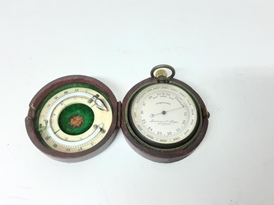 Lot 2505 - Late 19th / early 20th century pocket barometer by Lawrence & Mayo, London, 5cm diameter, in leather case with thermometer to underside of lid