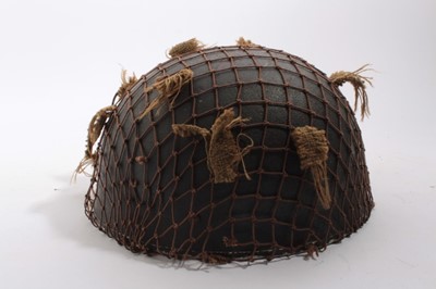 Lot 891 - Scarce Second World War British Military Airborne Forces steel helmet with Leather Chinstrap Harness and Original Combat Camouflage Net, helmet retains its original dark combat paint finish to the...