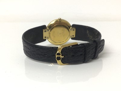 Lot 77 - Christian Dior wristwatch, the circular matte black dial set with brilliants, in circular gold plated case with reeded lugs, on original black leather strap with Christian Dior buckle, case 30mm di...