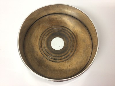 Lot 62 - Contemporary silver wine coaster with beaded border and turned wooden base, 13cm diameter