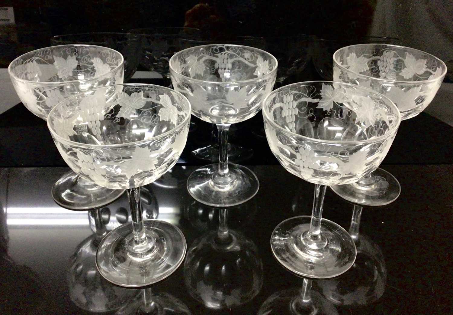 Lot 53 - Set of five cut and etched glass champagne bowls with vine and grape decorated borders