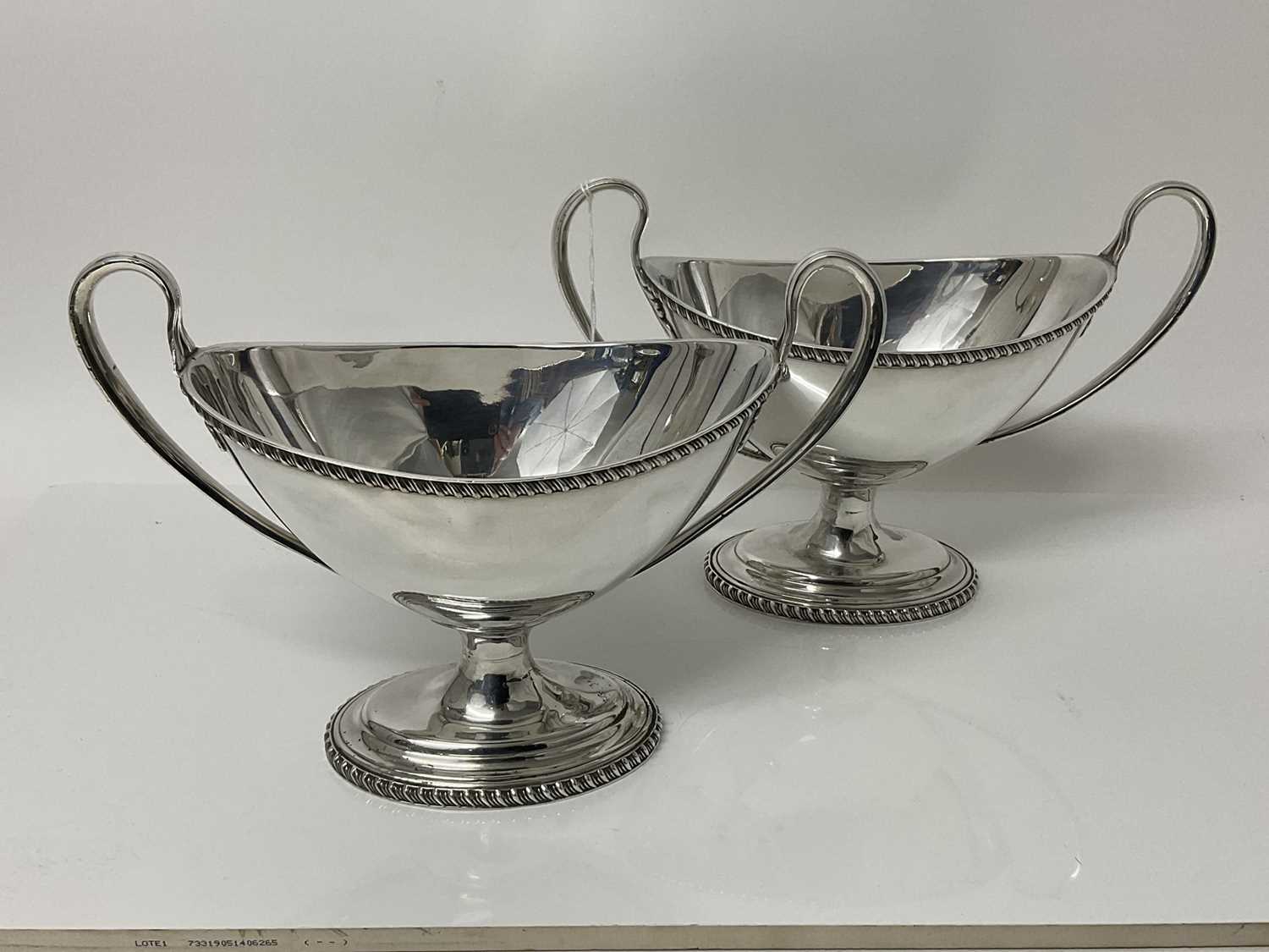 Lot 63 - Pair of 19th century silver plated two handed dishes of navette form with loop handles and gadrooned borders, on oval pedestal foot, 26cm wide