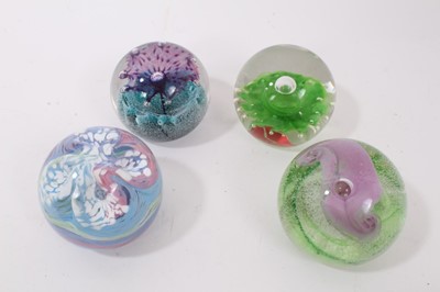 Lot 1219 - Nine Caithness Paperweights including Calypso, Amethyst Lace, Flower in the Rain, Fountain, Fleur, Sentinel Emerald and Multi coloured pattern. (9)