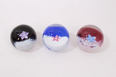 Lot 1219 - Nine Caithness Paperweights including Calypso, Amethyst Lace, Flower in the Rain, Fountain, Fleur, Sentinel Emerald and Multi coloured pattern. (9)