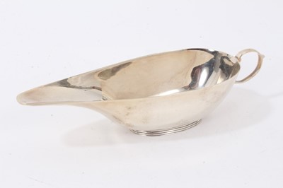 Lot 149 - Late Victorian silver sauce boat, Chester 1899, together with another silver sauce boat, Birmingham 1922, a silver cream jug, Sheffield 1899, and a silver sauce ladle, Glasgow 1837