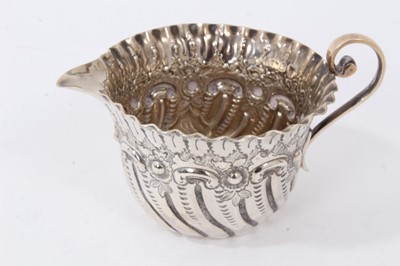 Lot 149 - Late Victorian silver sauce boat, Chester 1899, together with another silver sauce boat, Birmingham 1922, a silver cream jug, Sheffield 1899, and a silver sauce ladle, Glasgow 1837