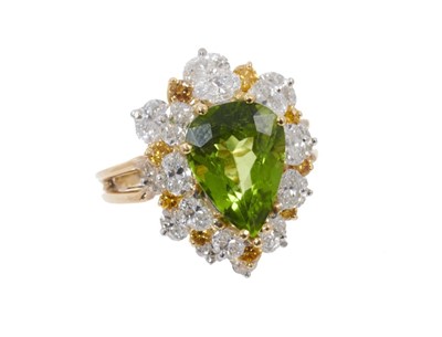 Lot 623 - Peridot and diamond pear shaped cluster cocktail ring with white and yellow diamonds