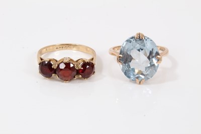 Lot 209 - 9ct gold oval faceted blue stone cocktail ring and 9ct gold garnet three stone ring (2)