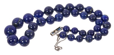 Lot 592 - Lapis lazuli bead necklace with sapphire and diamond clasp