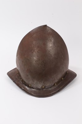 Lot 993 - Late 16th / early 17th century Cabasett helmet of typical shape, formed in one piece with high crown with ridge and 'pear stalk' terminal, rivets around a roped brim.