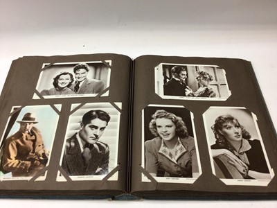 Lot 1423 - Postcards in two albums approximately Film Stars including Ginger Rogers, Fred Astaire