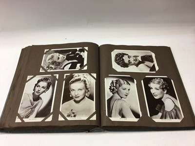 Lot 1423 - Postcards in two albums approximately Film Stars including Ginger Rogers, Fred Astaire
