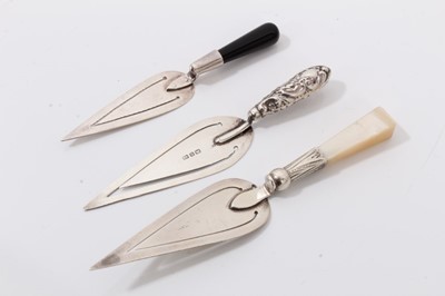 Lot 284 - White metal sword bookmark with banded agate handle and three silver trowel bookmarks (4)