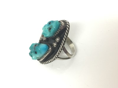 Lot 73 - Navajo style silver ring, of lozenge form, inset with turquoise-carved frogs, approx size M