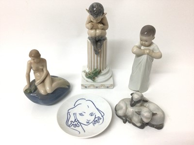 Lot 105 - Four Royal Copenhagen porcelain figures, including a fawn sat on a plinth, a child, two lambs and a mermaid, together with a Royal Copenhagen dish (5)