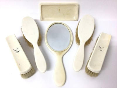 Lot 123 - Ivory dressing table set, to include four brushes, a mirror and a dish, retailed by Barrett & Sons, 63 & 64 Piccadilly