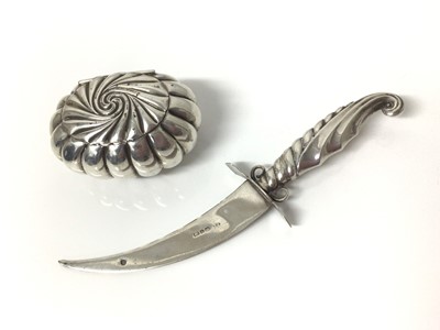 Lot 142 - Late Victorian silver box of oval fluted spiral form, 6cm x 4.5cm, together with a Victorian miniature silver dagger (Birmingham 1890), (2)
