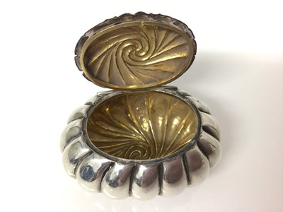 Lot 142 - Late Victorian silver box of oval fluted spiral form, 6cm x 4.5cm, together with a Victorian miniature silver dagger (Birmingham 1890), (2)
