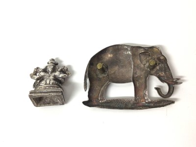 Lot 143 - Early 20th century white metal mount of an elephant, 5cm x 3.5cm, together with an antique Indian white metal deity, 2.5cm high