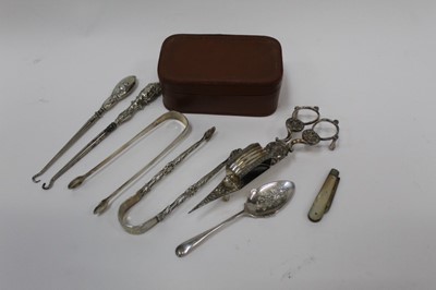 Lot 701 - Group of silver to include two pairs of Georgian sugar tongs, silver fruit knife, silver button hooks, grapefruit spoon and silver plated candle snuffers.