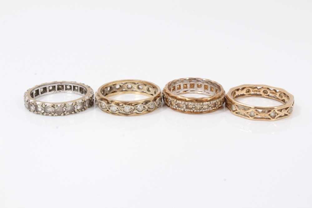 Lot 291 - Four 9ct gold synthetic white stone eternity rings