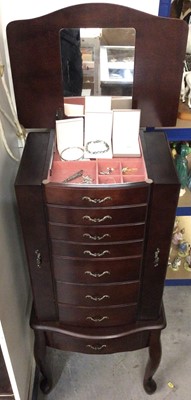 Lot 321 - Seven draw jewellery cabinet with hinged mirrored lid on four legs containing costume jewellery