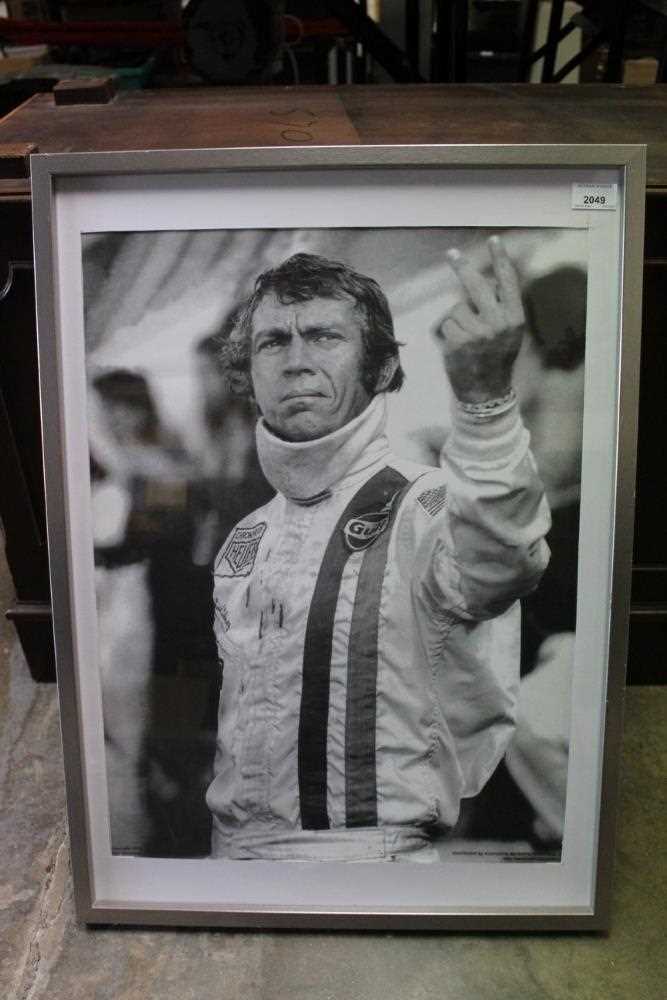 Lot 2049 - Steve McQueen Le Mans Black and White posted of his two fingered salute, in glazed frame, 72.5 x 52.5cm