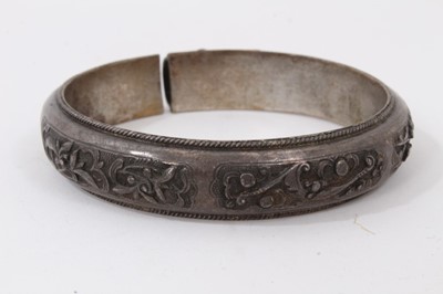 Lot 345 - Ten Chinese white metal bangles with floral scroll decoration