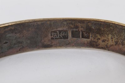 Lot 345 - Ten Chinese white metal bangles with floral scroll decoration