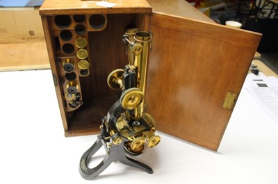 Lot 2549 - Large brass binocular microscope by Swift & Son, c.1880s, in wooden case holding eyepieces and lenses