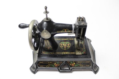 Lot 2580 - Vintage German painted cast iron miniature sewing machine